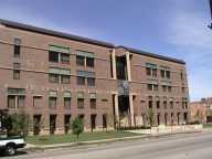 Brick building under a clear blue sky.